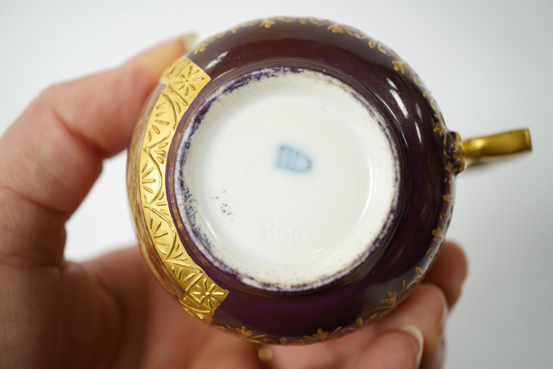 A late 19th century Vienna custard cup and saucer, outside and later decorated, beehive mark, 10cm high. Condition - good